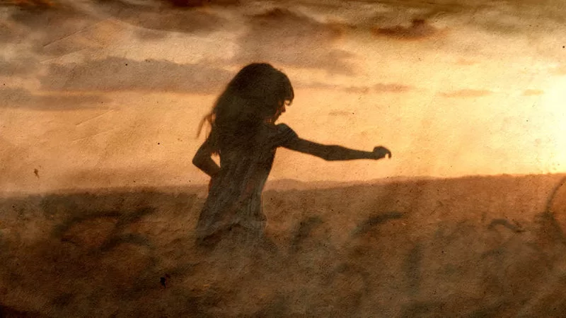 Girl running through field