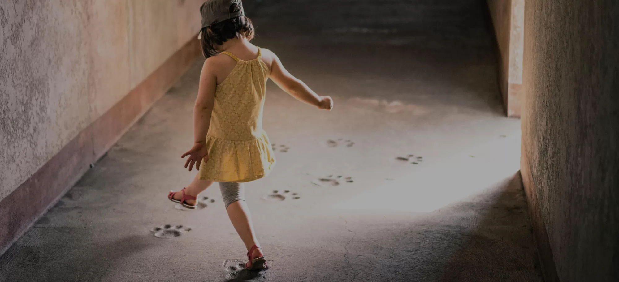 Young girl taking steps following footprints on floor